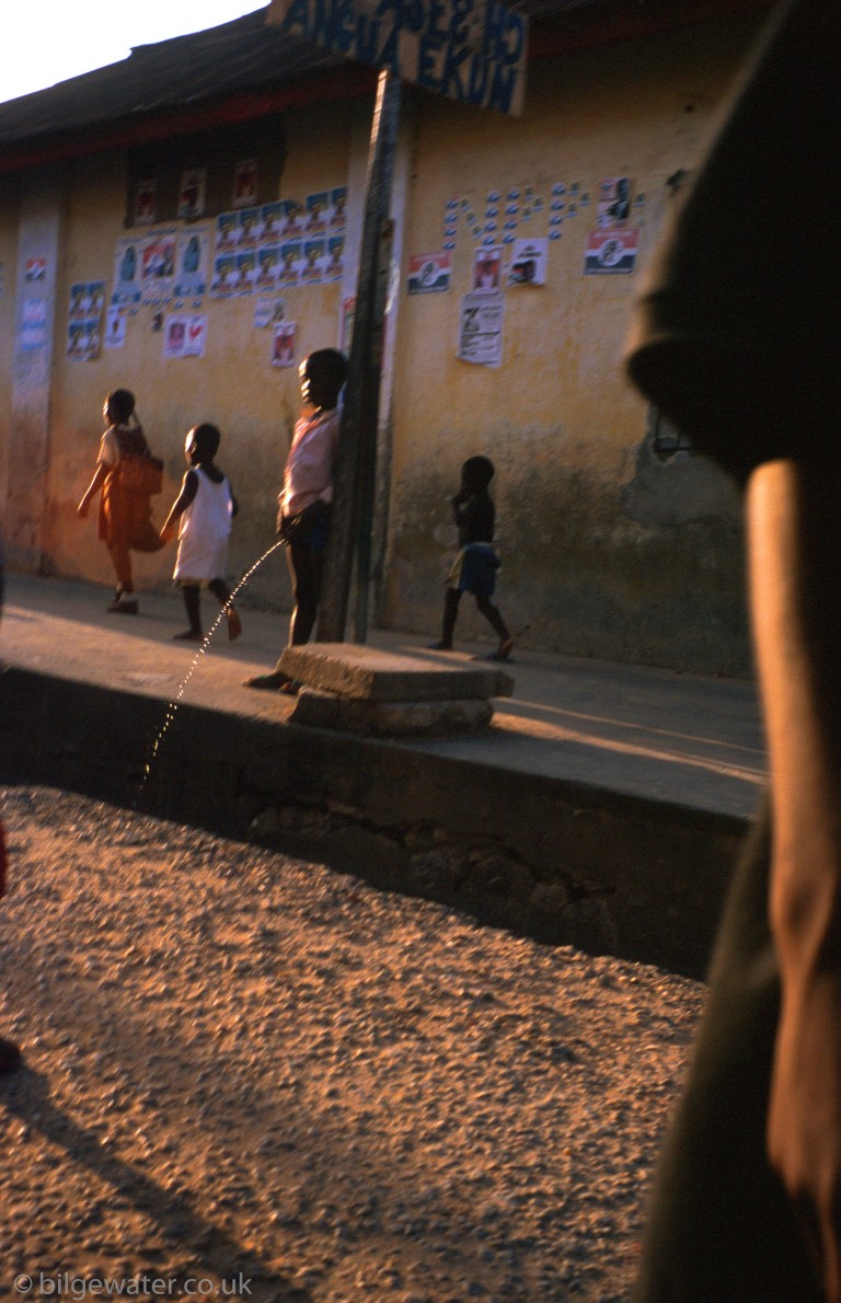 boys pissing in street, Ghana